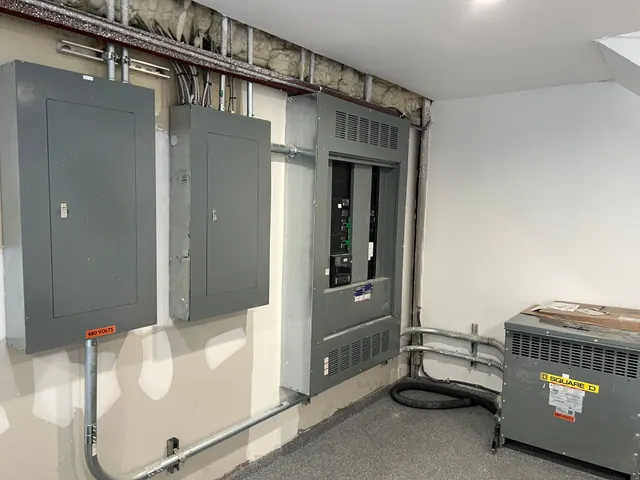 A commercial electrical room with panelboards, a distribution panel and a dry-type transformer