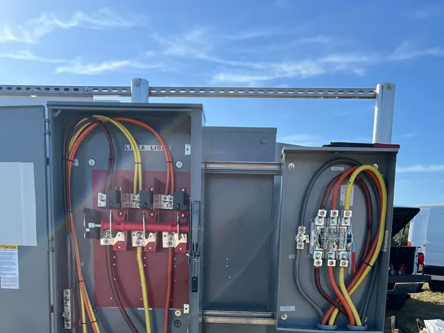 New outdoor service gear with terminated feeder conductors under a blue sky